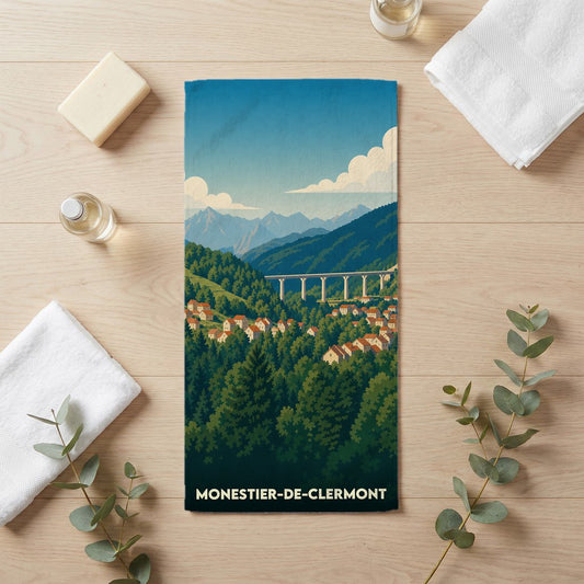 Serviette de bain souvenir de la ville de Monestier-de-Clermont illustrant un paysage de montagne stylisé.