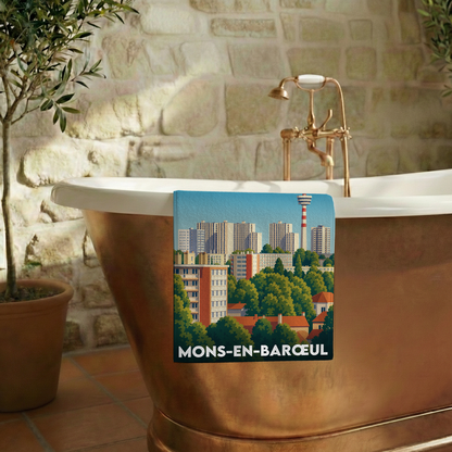 Serviette de bain souvenir de la ville de Mons-en-Barœul avec une illustration stylisée.