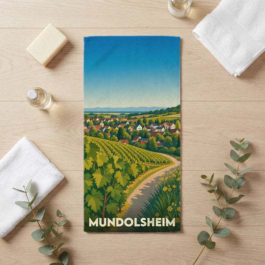Serviette de bain souvenir de la ville de Mundolsheim illustrant un paysage de vignobles et de village.