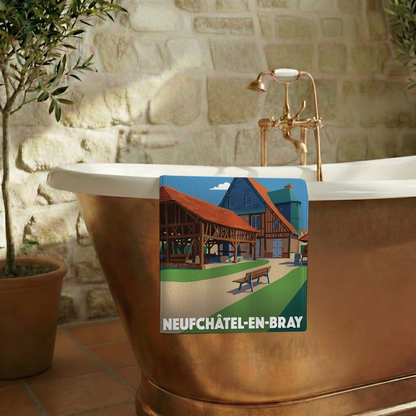 Serviette de bain souvenir de la ville de Neufchâtel-en-Bray avec une illustration stylisée de son architecture traditionnelle.