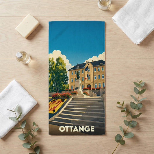 Serviette de bain souvenir de la ville de Ottange avec une illustration stylisée.