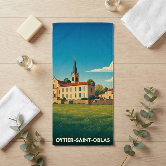 Serviette de bain souvenir de la ville de Oytier-Saint-Oblas avec une illustration stylisée d'un paysage de campagne.