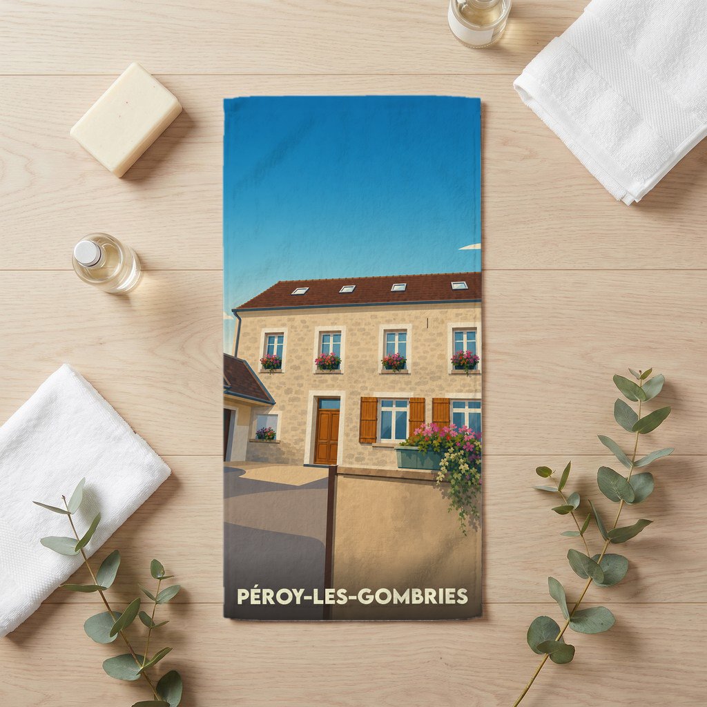 Serviette de bain souvenir de la ville de Péroy-les-Gombries avec une illustration stylisée d'une maison traditionnelle.
