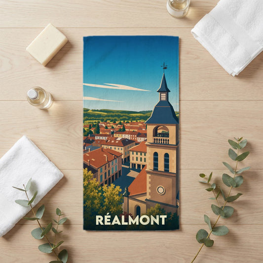 Serviette de bain souvenir de la ville de Réalmont avec une illustration stylisée.
