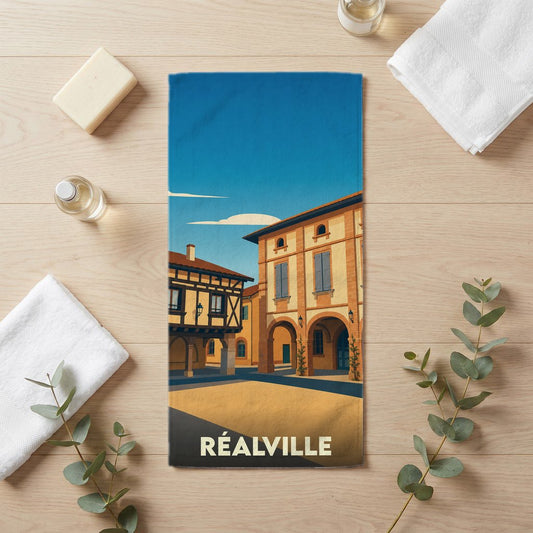 Serviette de bain souvenir de la ville de Réalville avec une illustration stylisée de son architecture.