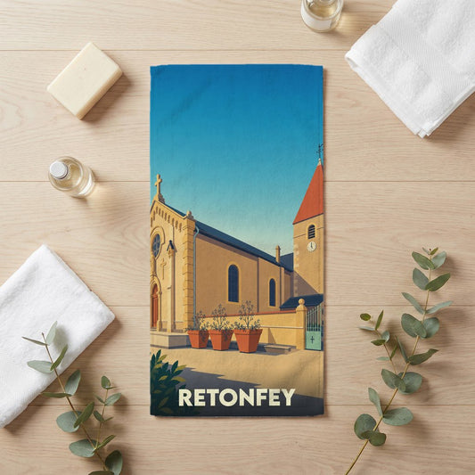 Serviette de bain souvenir de la ville de Retonfey illustrée d'un dessin stylisé de son église.