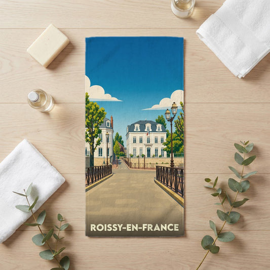 Serviette de bain souvenir de Roissy-en-France avec une illustration stylisée de la ville.