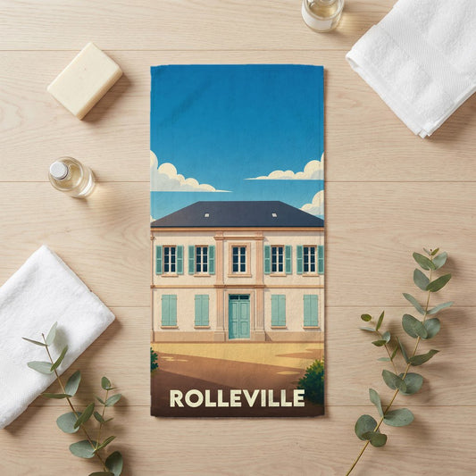 Serviette de bain souvenir de la ville de Rolleville avec une illustration stylisée d'un bâtiment classique.