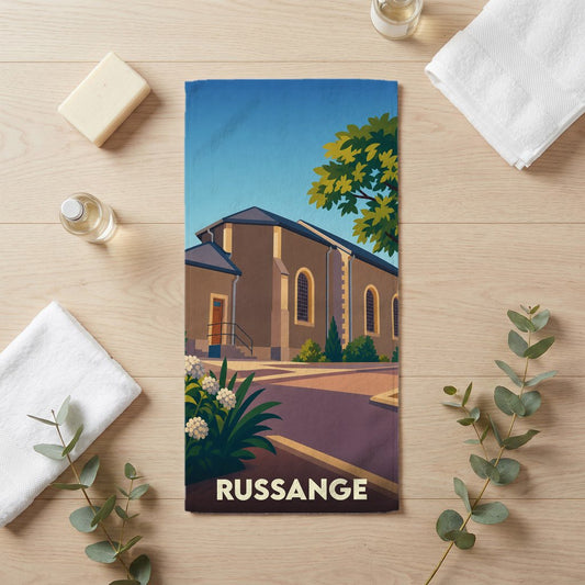 Serviette de bain souvenir de la ville de Russange avec une illustration stylisée.