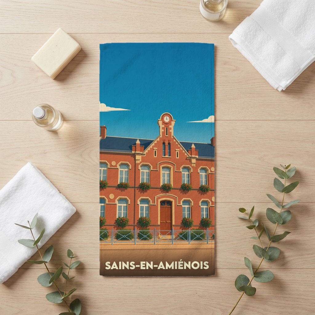 Serviette de bain souvenir de la ville de Sains-en-Amiénois avec une illustration stylisée d'un bâtiment en briques.