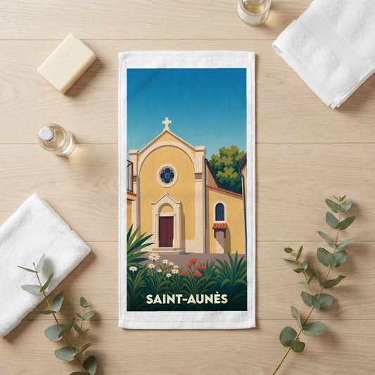 Serviette de bain souvenir de la ville de Saint-Aunès avec une illustration stylisée d'une église locale.