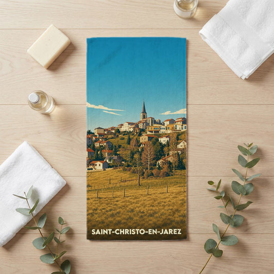 Serviette de bain souvenir de la ville de Saint-Christo-en-Jarez avec une illustration stylisée du village.