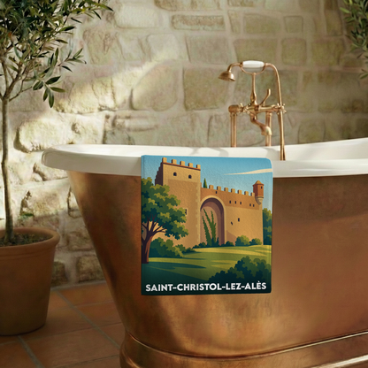 Serviette de bain souvenir de Saint-Christol-lez-Alès illustrant une porte fortifiée historique.