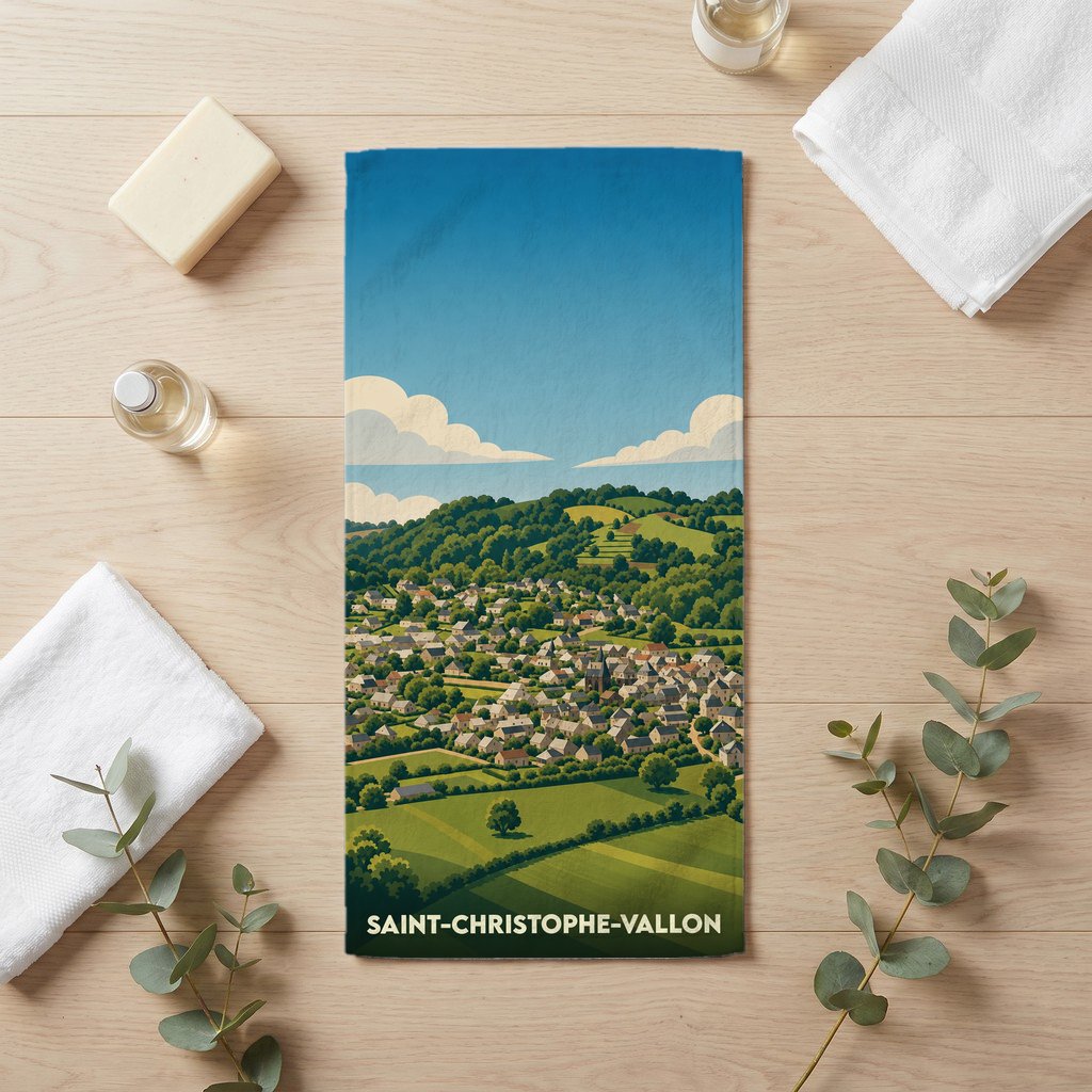 Serviette de bain souvenir de Saint-Christophe-Vallon avec une illustration stylisée du village et de son paysage vallonné.