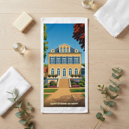 Serviette de bain souvenir de la ville de Saint-Étienne-au-Mont avec une illustration stylisée d'une demeure historique.