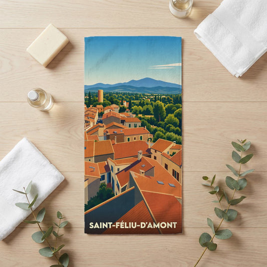 Serviette de bain souvenir de Saint-Féliu-d'Amont avec une illustration stylisée de ses toits orangés et des montagnes.
