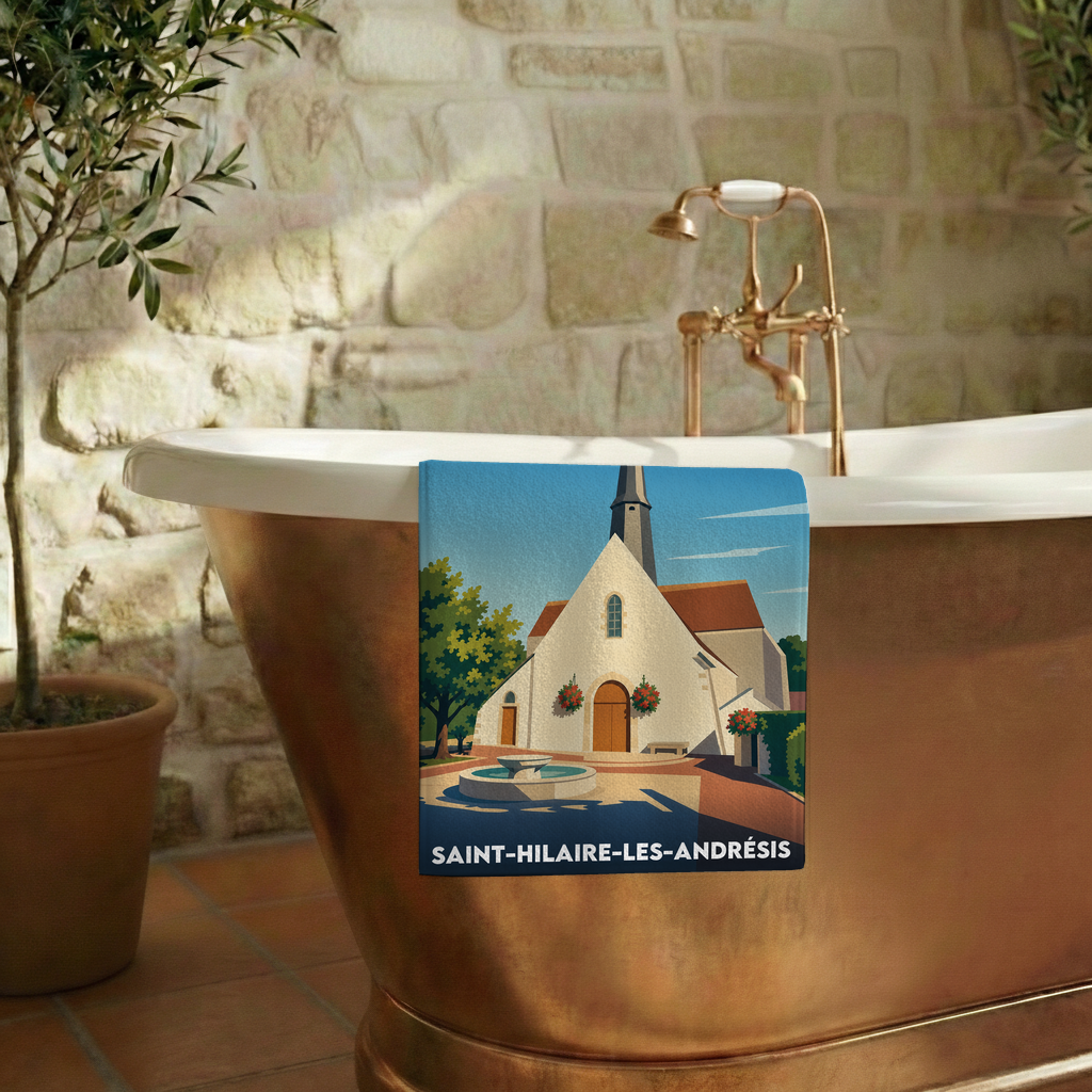Serviette de bain souvenir de Saint-Hilaire-les-Andrésis avec une illustration stylisée de la ville.