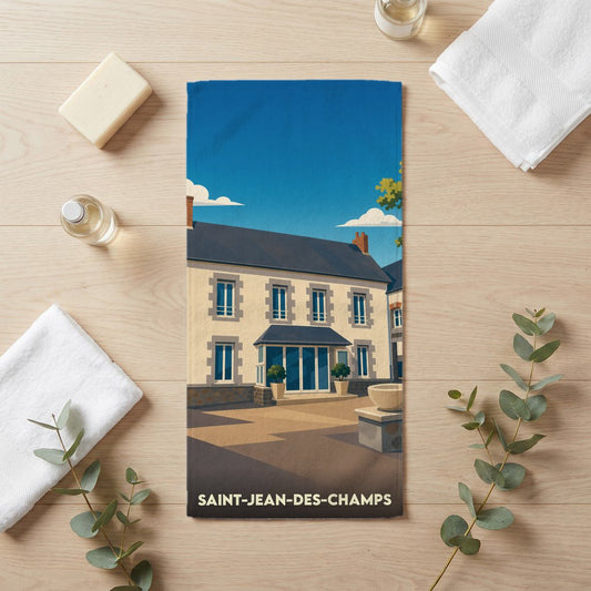 Serviette de bain souvenir de la ville de Saint-Jean-des-Champs avec une illustration stylisée.