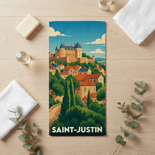 Serviette de bain souvenir de la ville de Saint-Justin avec une illustration stylisée d'un château surplombant un village.