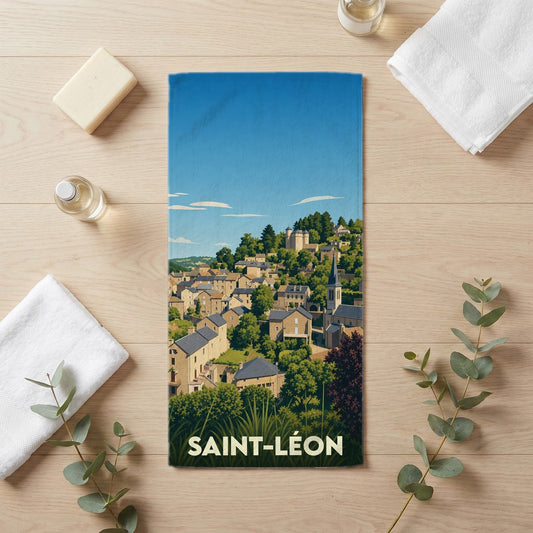 Serviette de bain souvenir de la ville de Saint-Léon avec une illustration stylisée d'un village perché.