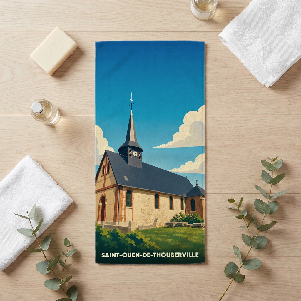 Serviette de bain souvenir de Saint-Ouen-de-Thouberville illustrée d'une église sous un ciel bleu.