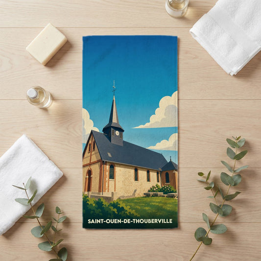 Serviette de bain souvenir de Saint-Ouen-de-Thouberville illustrée d'une église sous un ciel bleu.