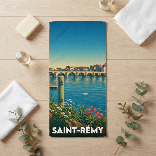 Serviette de bain souvenir de la ville de Saint-Rémy avec une illustration stylisée d'un paysage fluvial.