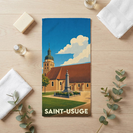 Serviette de bain souvenir de la ville de Saint-Usuge avec une illustration stylisée de son église et d'un monument.