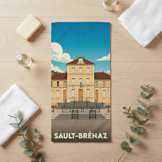 Serviette de bain souvenir de la ville de Sault-Brénaz avec une illustration stylisée de son hôtel de ville.