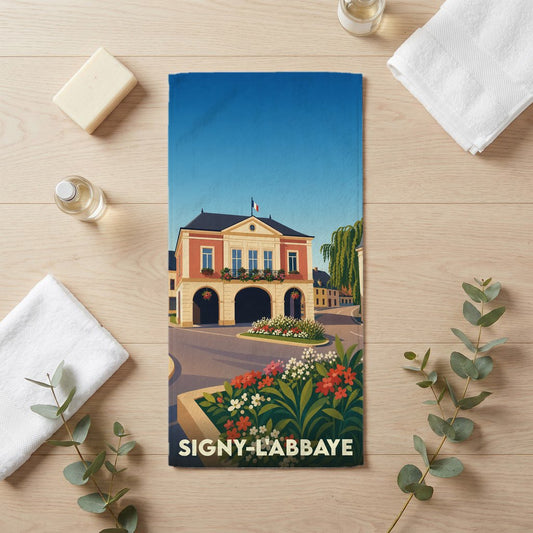 Serviette de bain souvenir de la ville de Signy-l'Abbaye avec une illustration stylisée de son hôtel de ville.