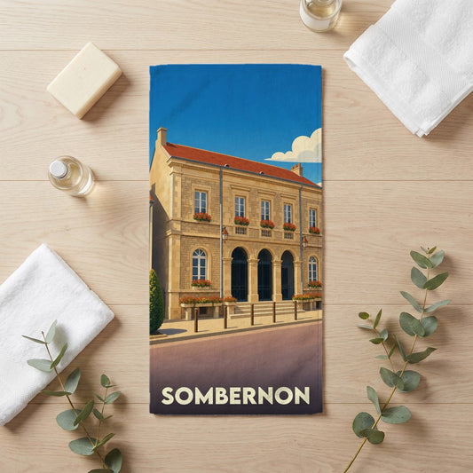 Serviette de bain souvenir de la ville de Sombernon avec une illustration stylisée d'un bâtiment historique.