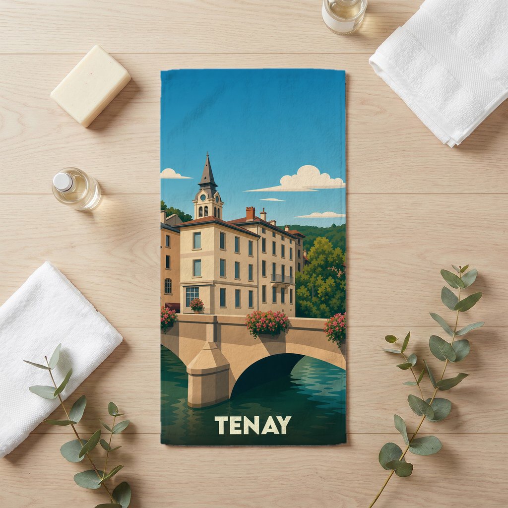Serviette de bain souvenir de la ville de Tenay avec une illustration stylisée d'un pont et de bâtiments anciens.