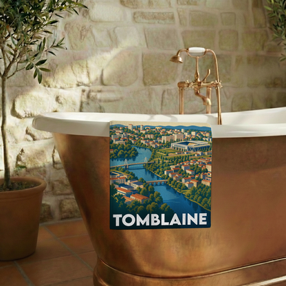 Serviette de bain souvenir de la ville de Tomblaine avec une illustration stylisée.