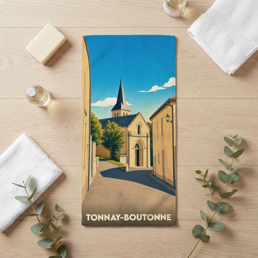 Serviette de bain souvenir de la ville de Tonnay-Boutonne avec une illustration stylisée de son église.