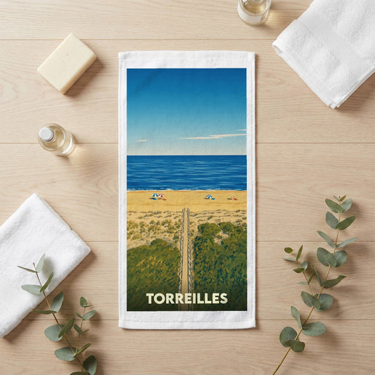 Serviette de bain souvenir de la ville de Torreilles avec une illustration de plage stylisée.