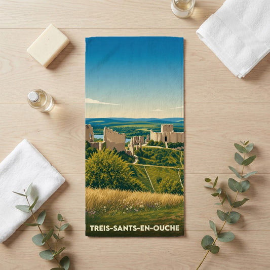 Serviette de bain souvenir de la ville de Treis-Sants-en-Ouche avec une illustration de ruines médiévales dans un paysage vallonné.