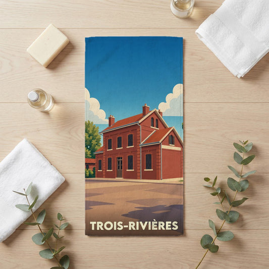 Serviette de bain souvenir de la ville de Trois-Rivières avec une illustration stylisée d'un bâtiment historique.