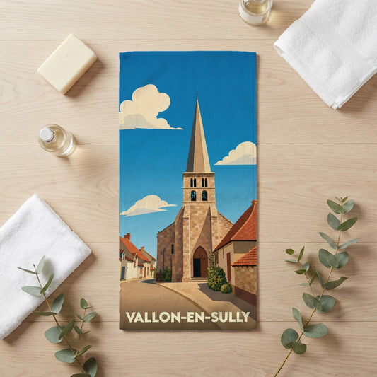 Serviette de bain souvenir de Vallon-en-Sully avec une illustration de son église sous un ciel bleu.