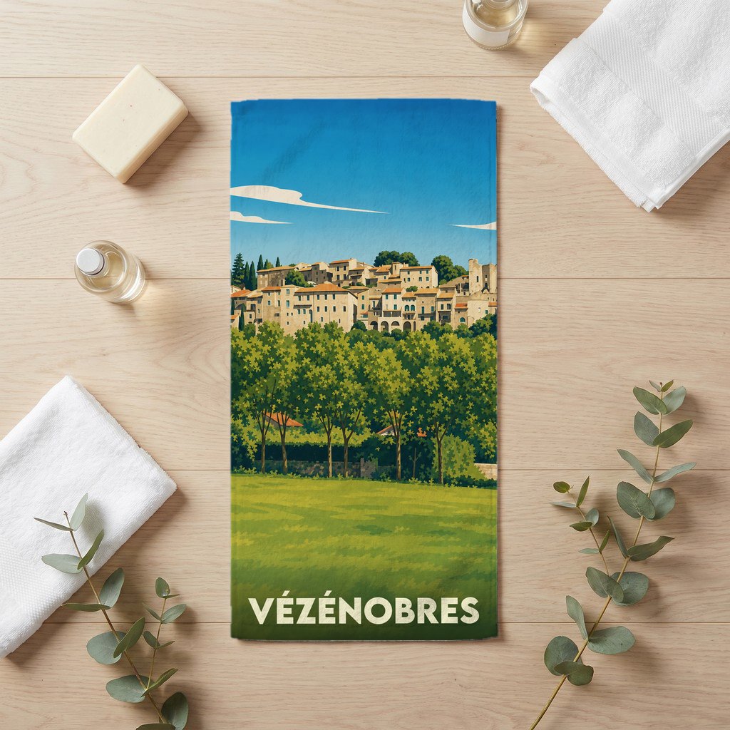 Serviette de bain souvenir de la ville de Vézénobres avec une illustration stylisée d'un village perché.