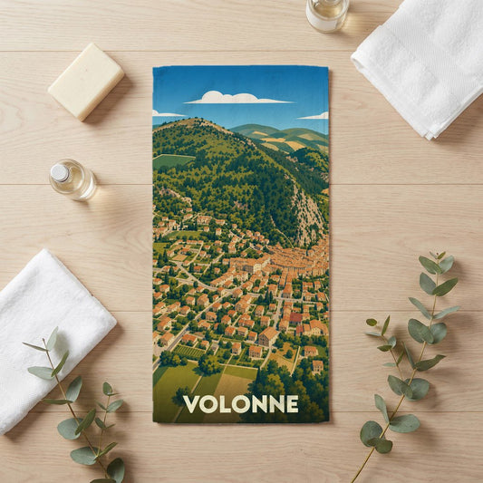 Serviette de bain souvenir de la ville de Volonne ornée d'une illustration stylisée de son paysage urbain et montagneux.