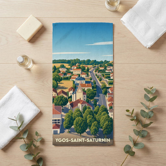 Serviette de bain souvenir de la ville d'Ygos-Saint-Saturnin avec une illustration de paysage urbain stylisé.