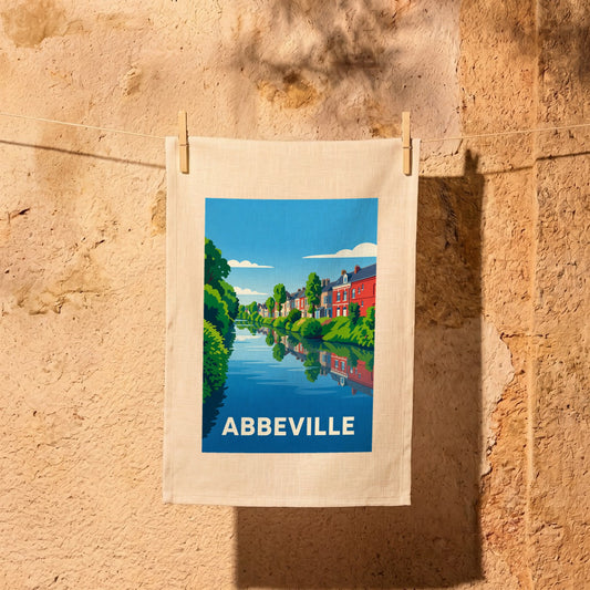 Torchon souvenir de la ville d'Abbeville avec une illustration stylisée de maisons colorées se reflétant dans l'eau.