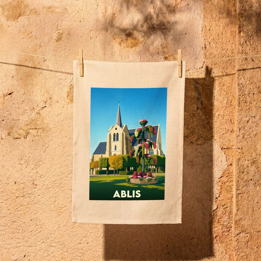 Torchon souvenir de la ville d'Ablis avec une illustration stylisée de son église et d'un massif floral.