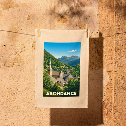 Torchon souvenir de la ville d'Abondance illustré par un paysage de montagne stylisé.