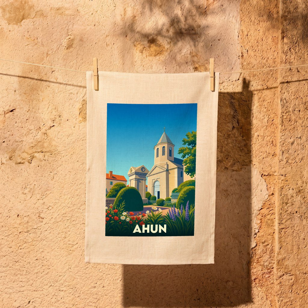Torchon souvenir de la ville d'Ahun orné d'une illustration stylisée de son église et de jardins fleuris.