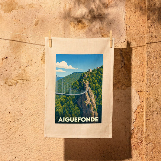 Torchon souvenir de la ville d'Aiguefonde illustré d'une passerelle suspendue dans un paysage montagneux.