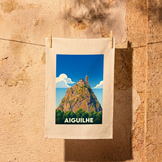 Torchon souvenir de la ville d'Aiguilhe avec une illustration stylisée de son rocher et de sa chapelle.