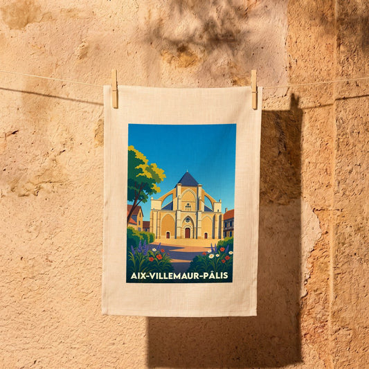 Torchon souvenir de la ville d'Aix-Villemaur-Pâlis illustré d'une église de style gothique sous un ciel bleu.