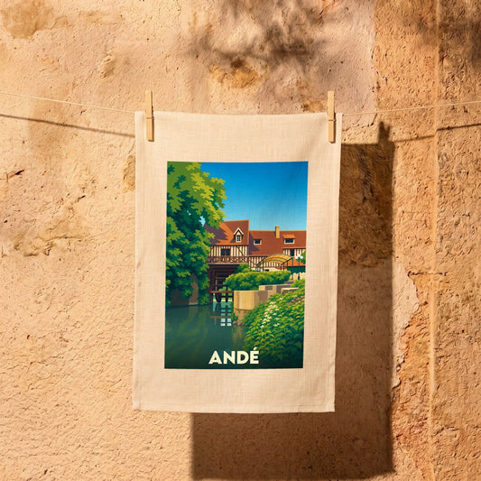 Torchon souvenir de la ville d'Andé avec une illustration stylisée d'un moulin au bord de l'eau.