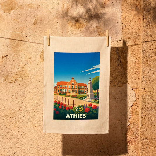 Torchon souvenir de la ville d'Athies orné d'une illustration stylisée de sa mairie et de son monument aux morts.